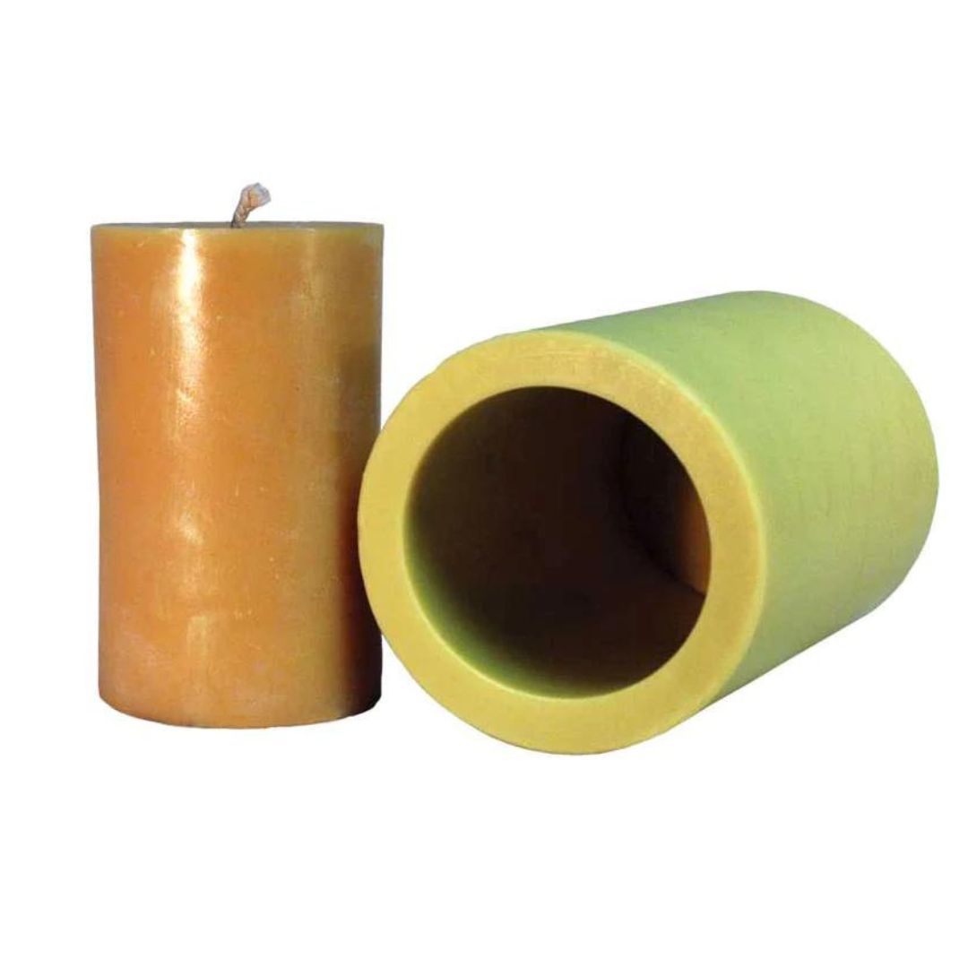 A cylindrical candle mold alongside a 3-inch by 5-inch candle that was made using the mold, displayed against a white background.