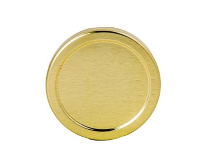 A gold, metal lid used to seal glass jars on a white background