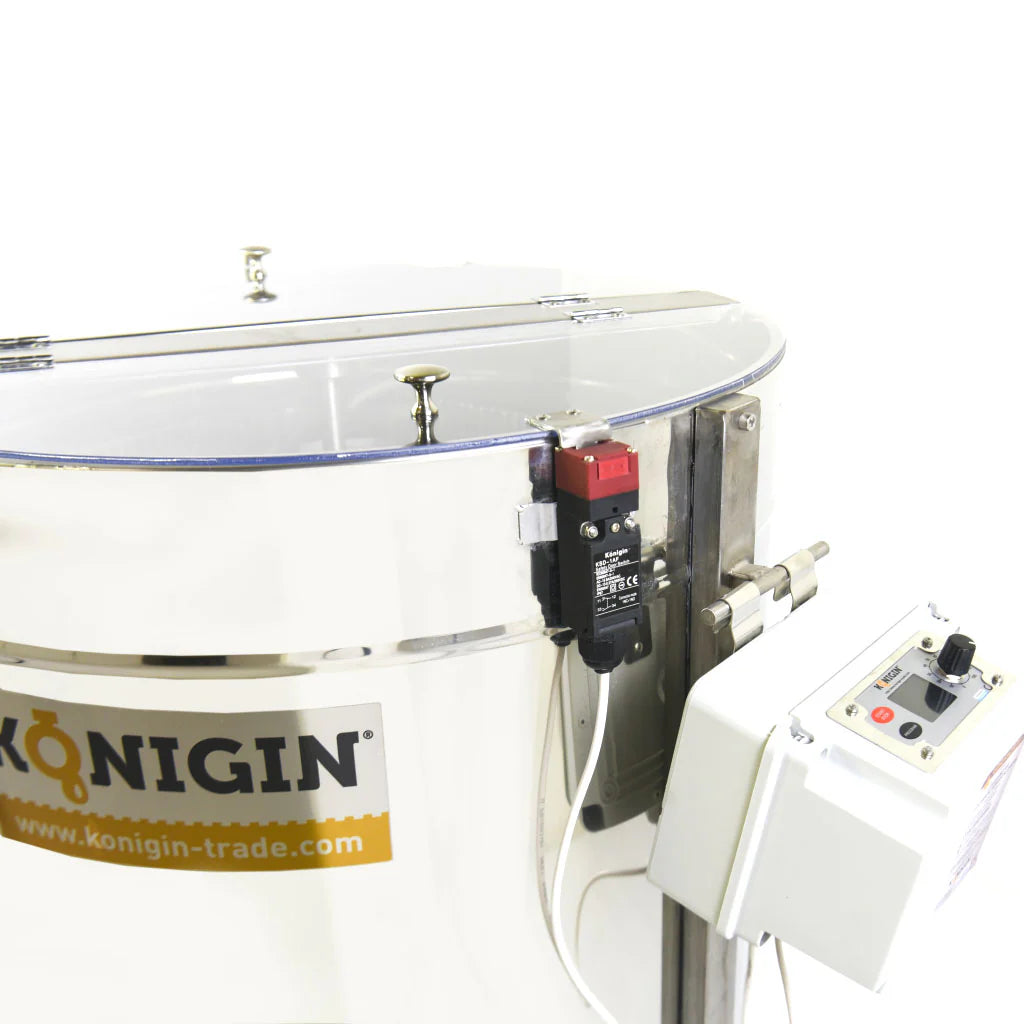 A close up of the KONIGIN motorized honey extractor made of stainless steel, emphasizing the control knobs on a white background