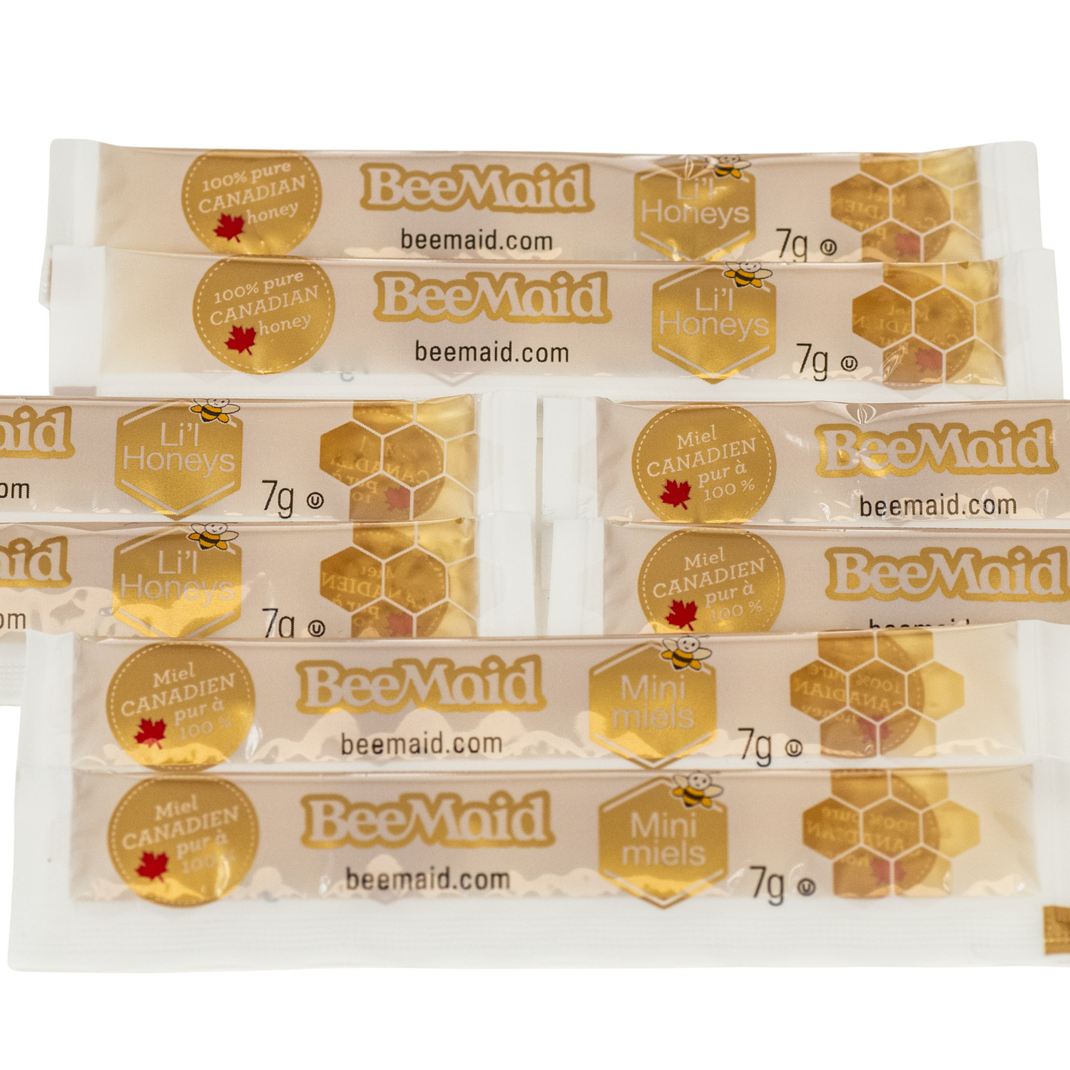 Multiple BeeMaid honey packets on a white background