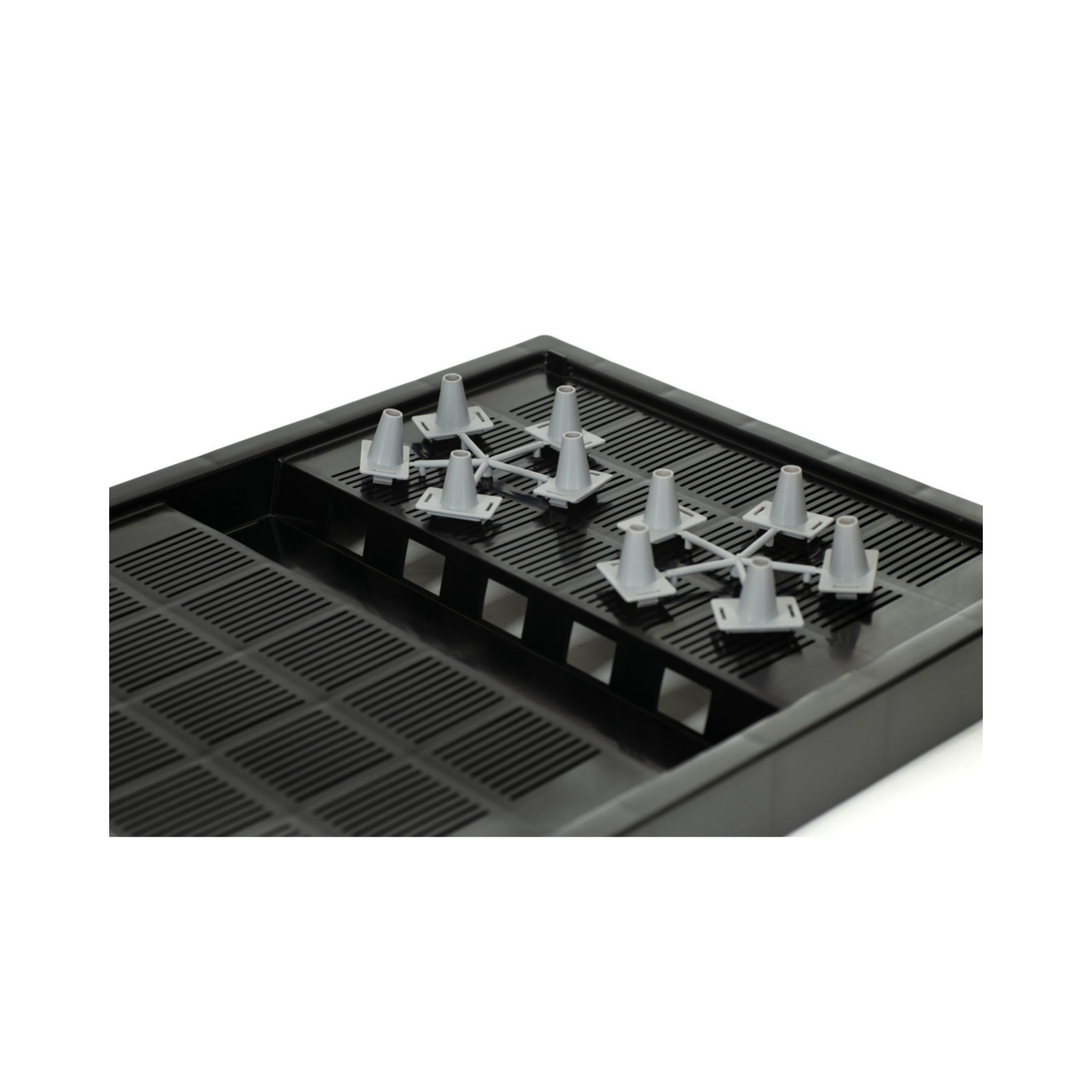 Black plastic tray with multiple small white connectors on a white background