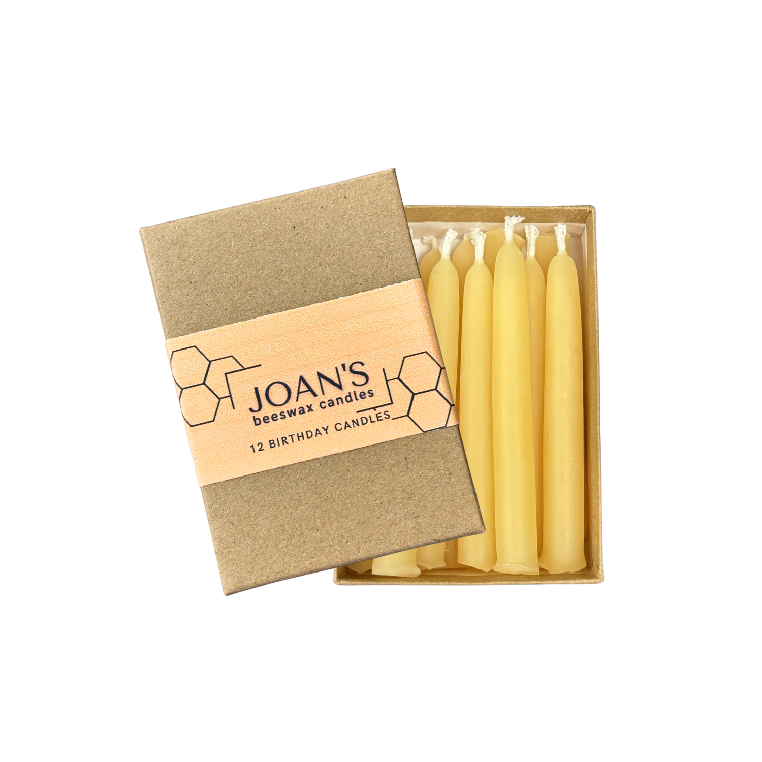 Cardboard box of Joan's 12 beeswax birthday candles on a white background