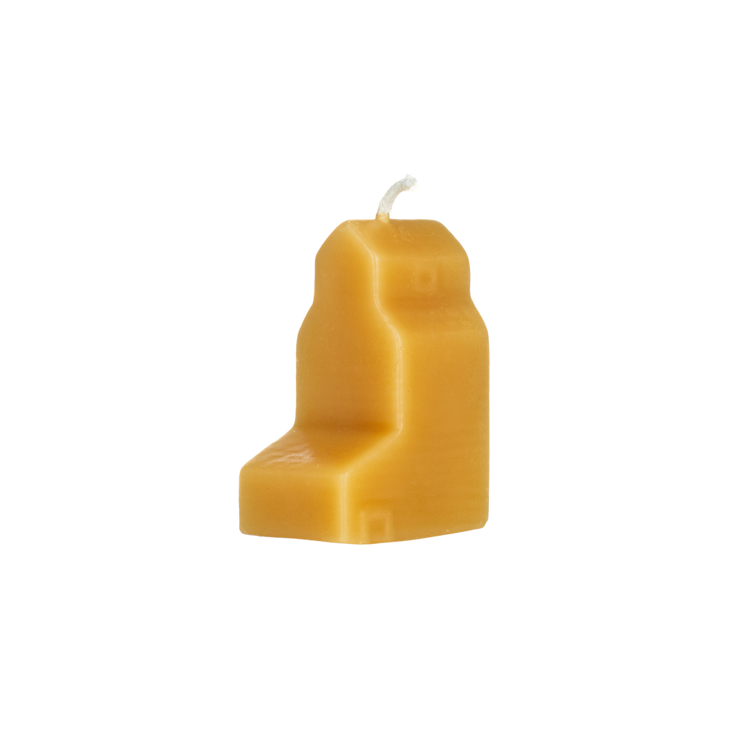 Beeswax candle shaped like a grain elevator on a white background