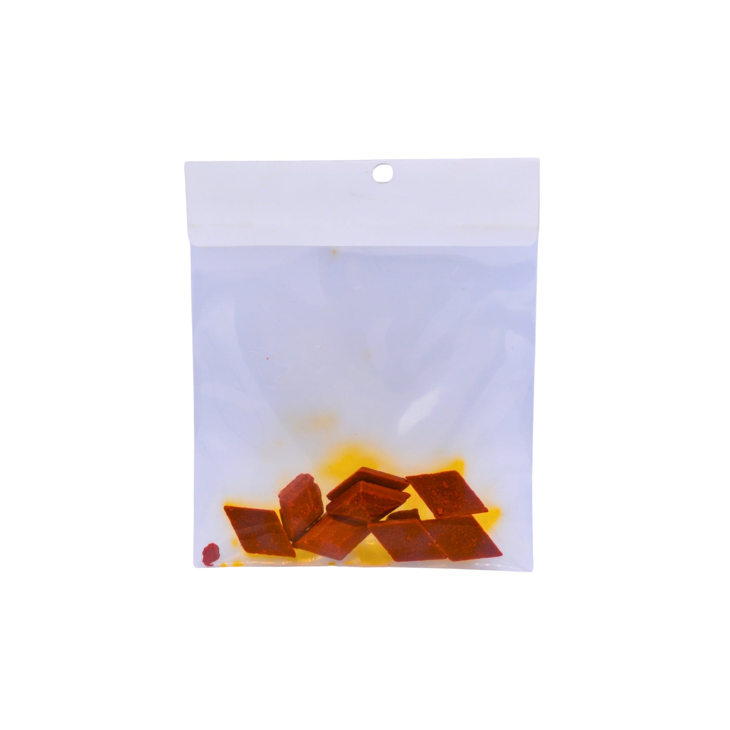 A clear plastic bag with several orange coloured dye buds shown on a plain white background.