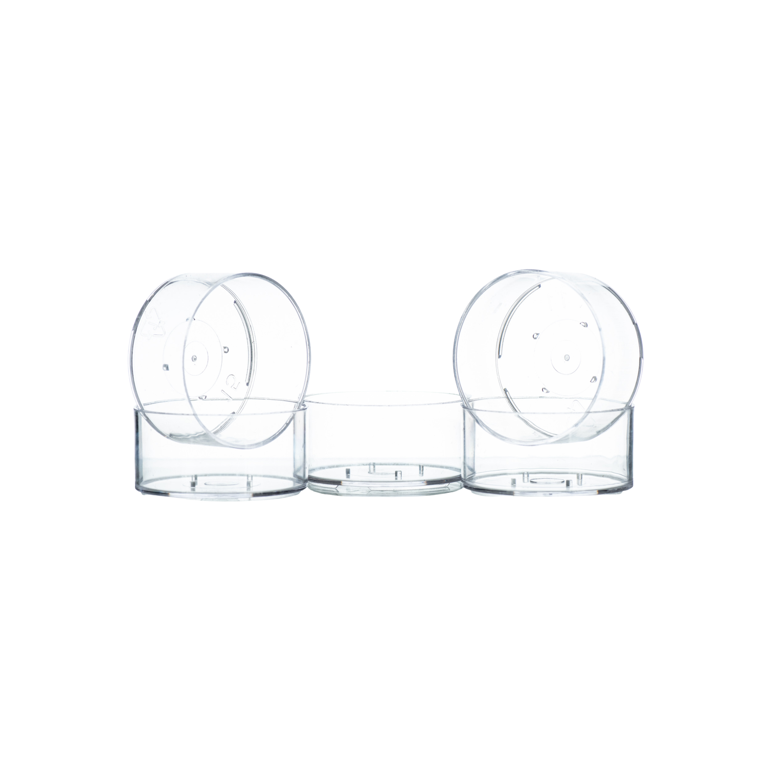 Five clear plastic tealight cups, designed for candle making on a white background