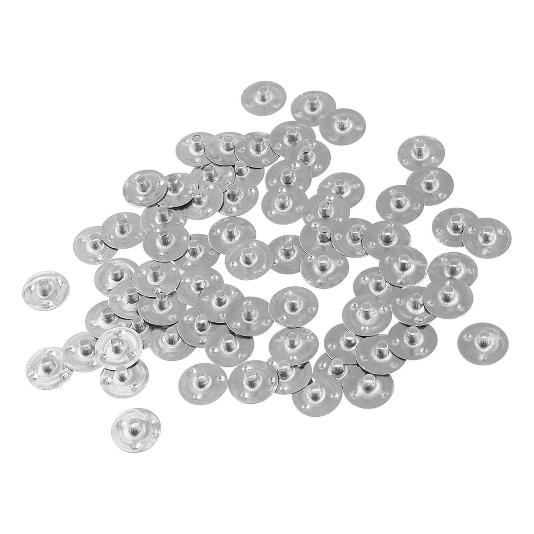 A collection of silver wick tabs used for candle making, displayed on a white background.