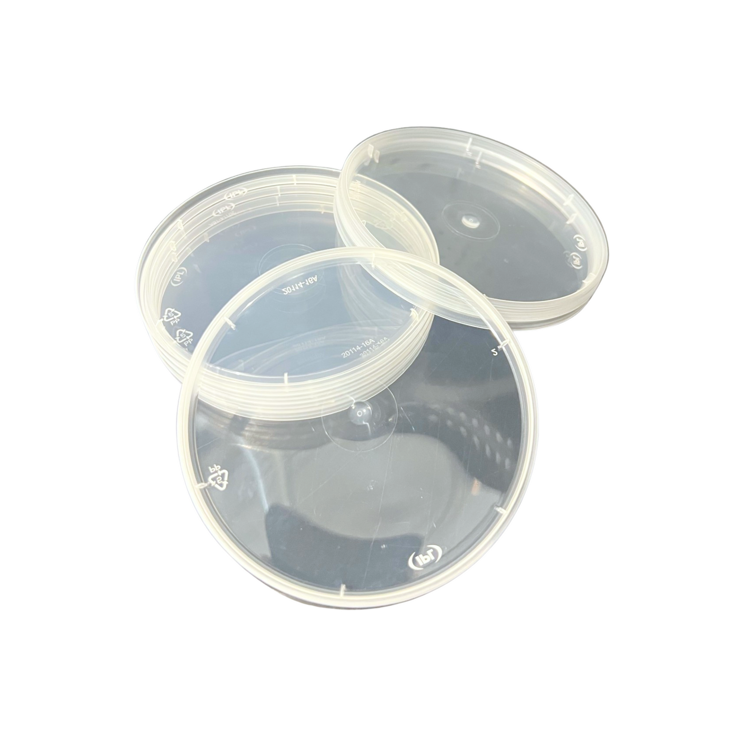 stack of clear plastic round lids on a white background