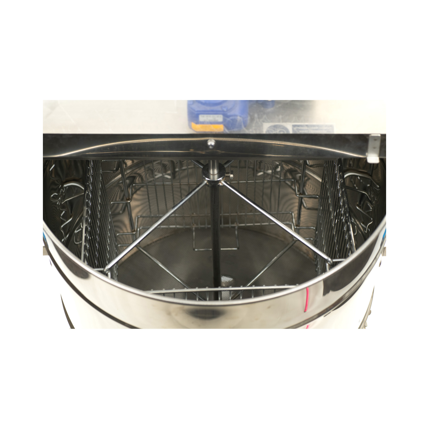 Stainless steel extractor interior with racks on a white background