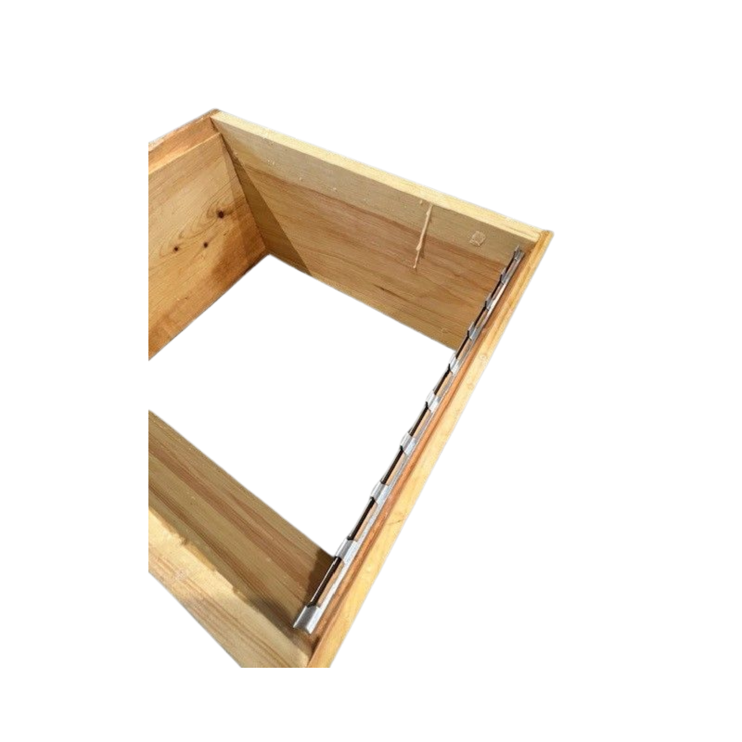 A wooden bee box demonstrating the placement of the spacer rest on a white background