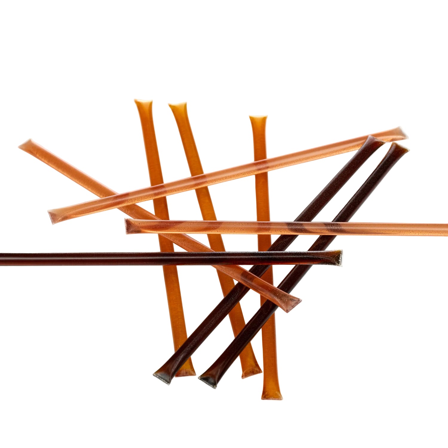 A collection of liquid honey sticks with varying colors, arranged on a white background.