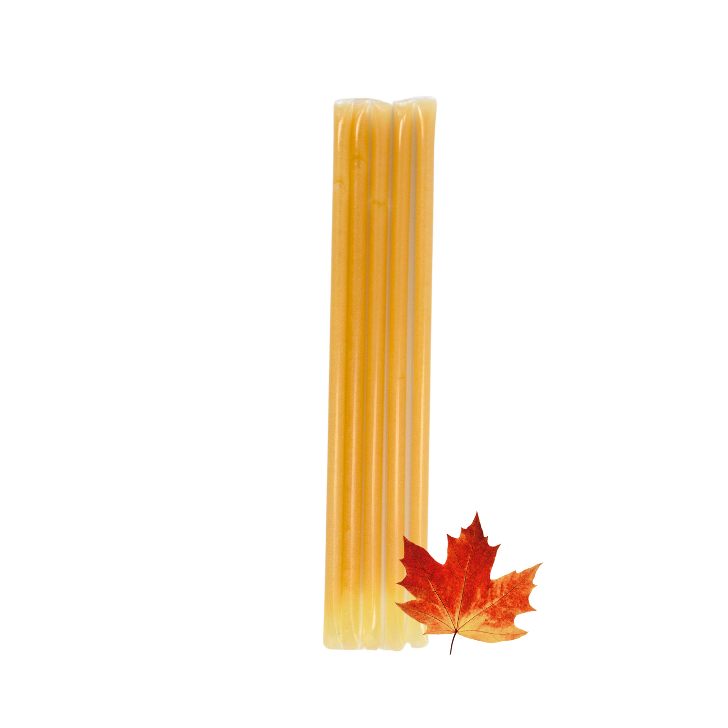 Five maple creamed honey stixs standing upright beside a small Maple leaf on a white background.