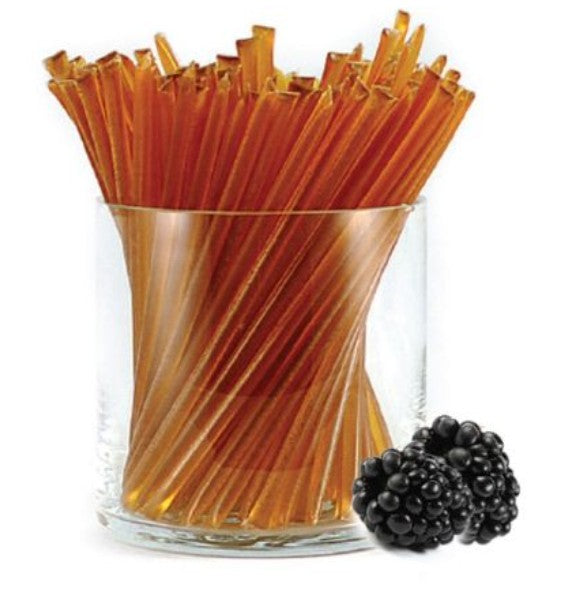 A glass jar of liquid honey stixs, in the flavour blackberry on a white background.