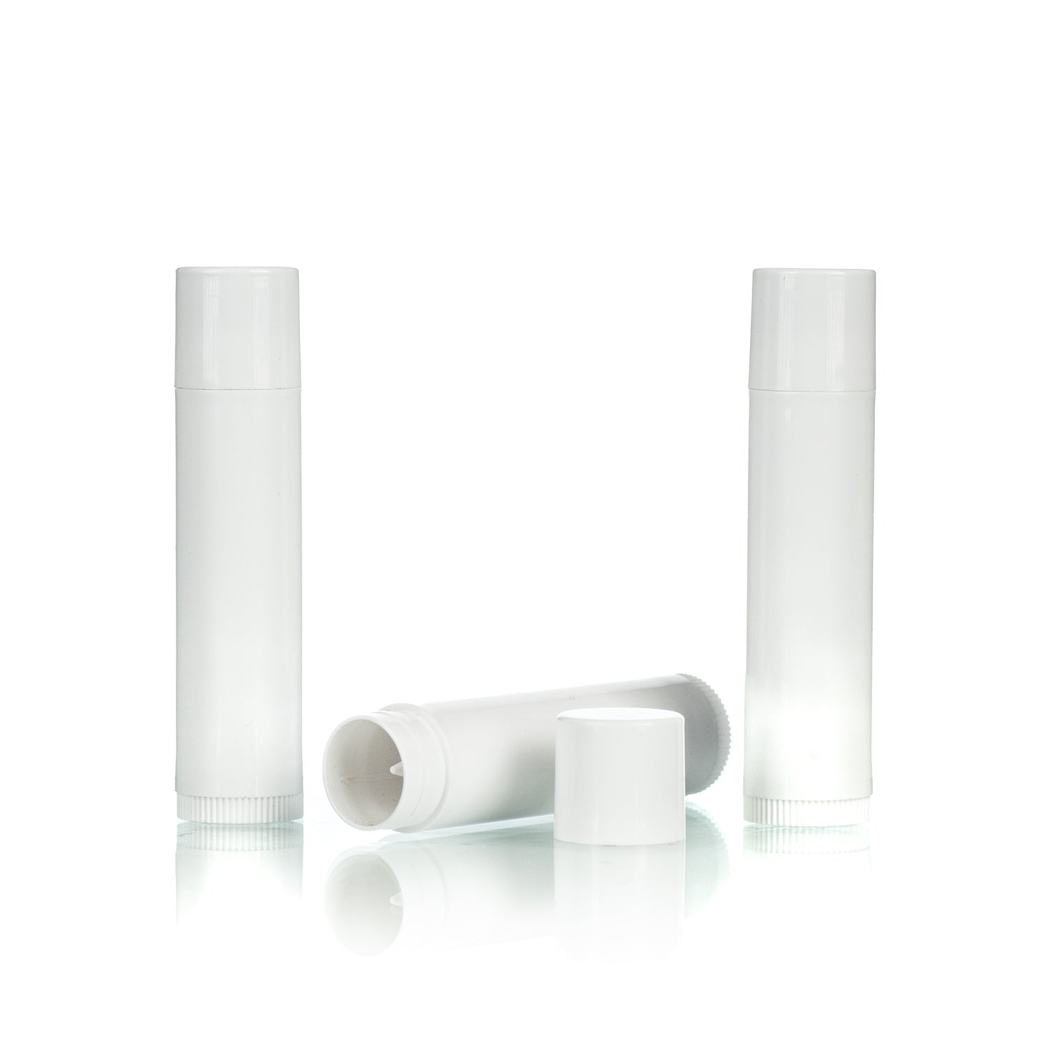 Three white, cylindrical lip balm containers, two stand upright while one lies down with its cap off on a white background