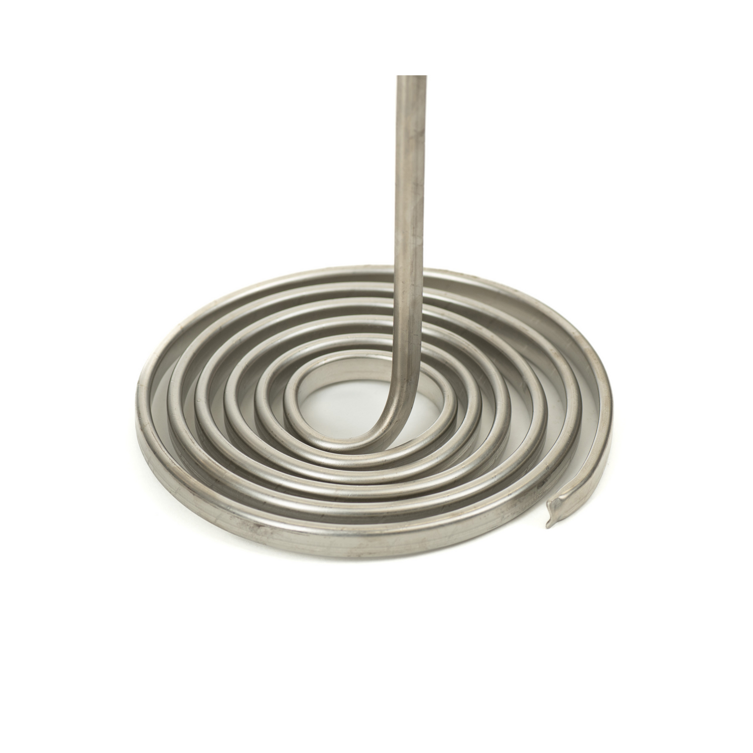 A close up of the coiled heating element of a silver-colored pail melter