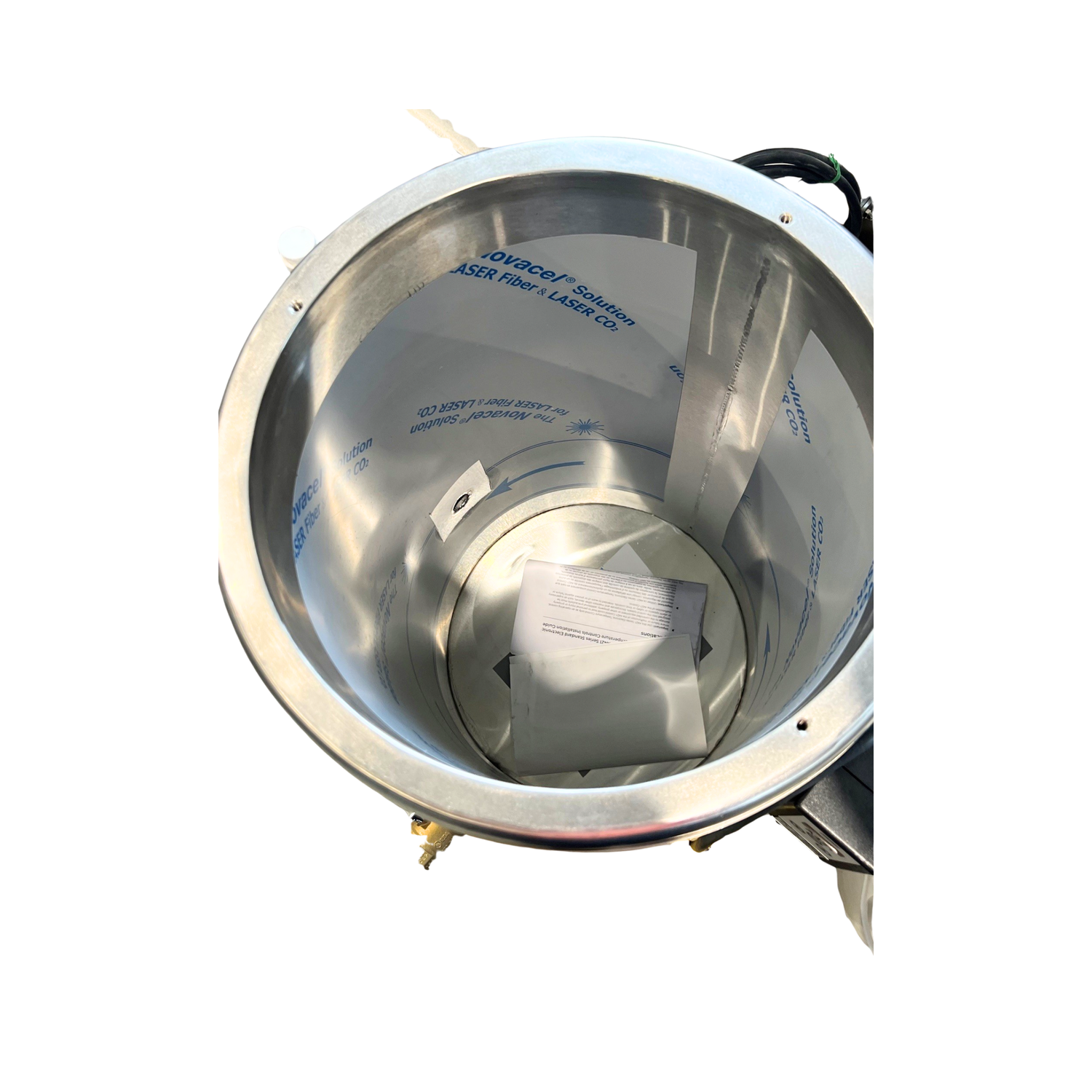 A birds eye view of the inside of a stainless steel wax melter with visible branding on a white background