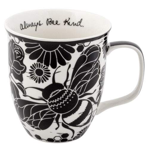 A black and white ceramic mug with floral and bee patterns, and an inspirational message inside.