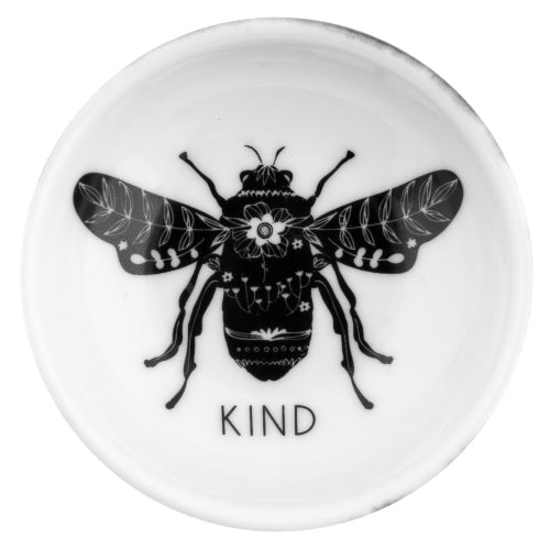 A white ceramic ring bowl with a black bee illustration in the center and the word 'KIND' written at the bottom on a white background