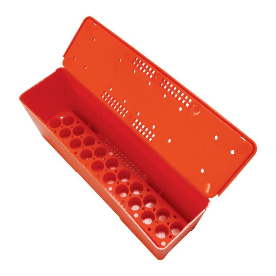 A red battery box designed to hold queen cages for beekeeping, with ventilation holes and a compartment for food and water.