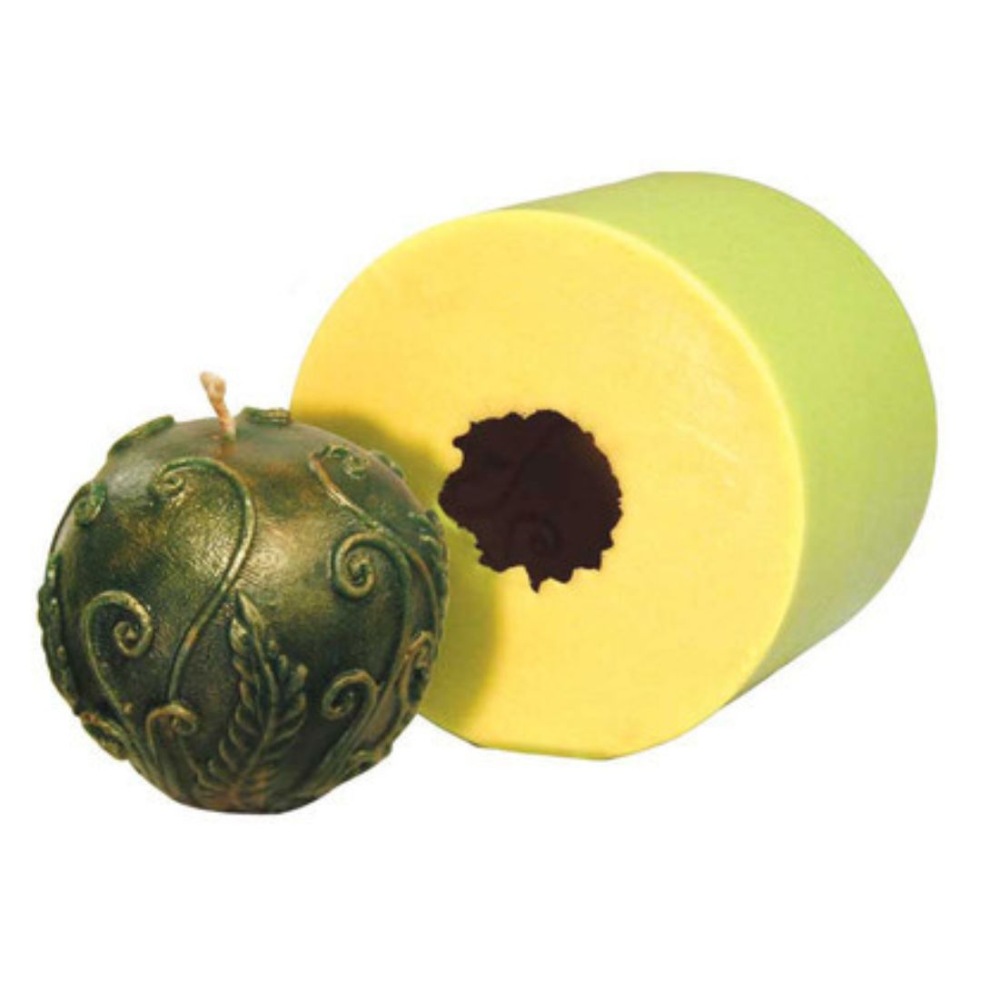 A candle mold with a resulting decorative ball candle, showing both the mold and the green candle it created, displayed on a white background