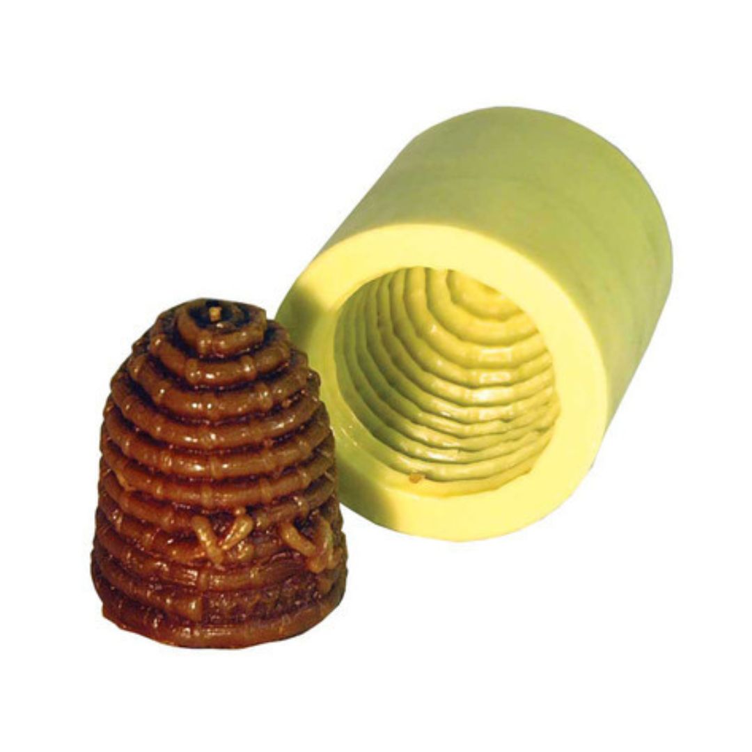 A small skep candle mold, with a corresponding candle shape beside it, made from the mold on a white background