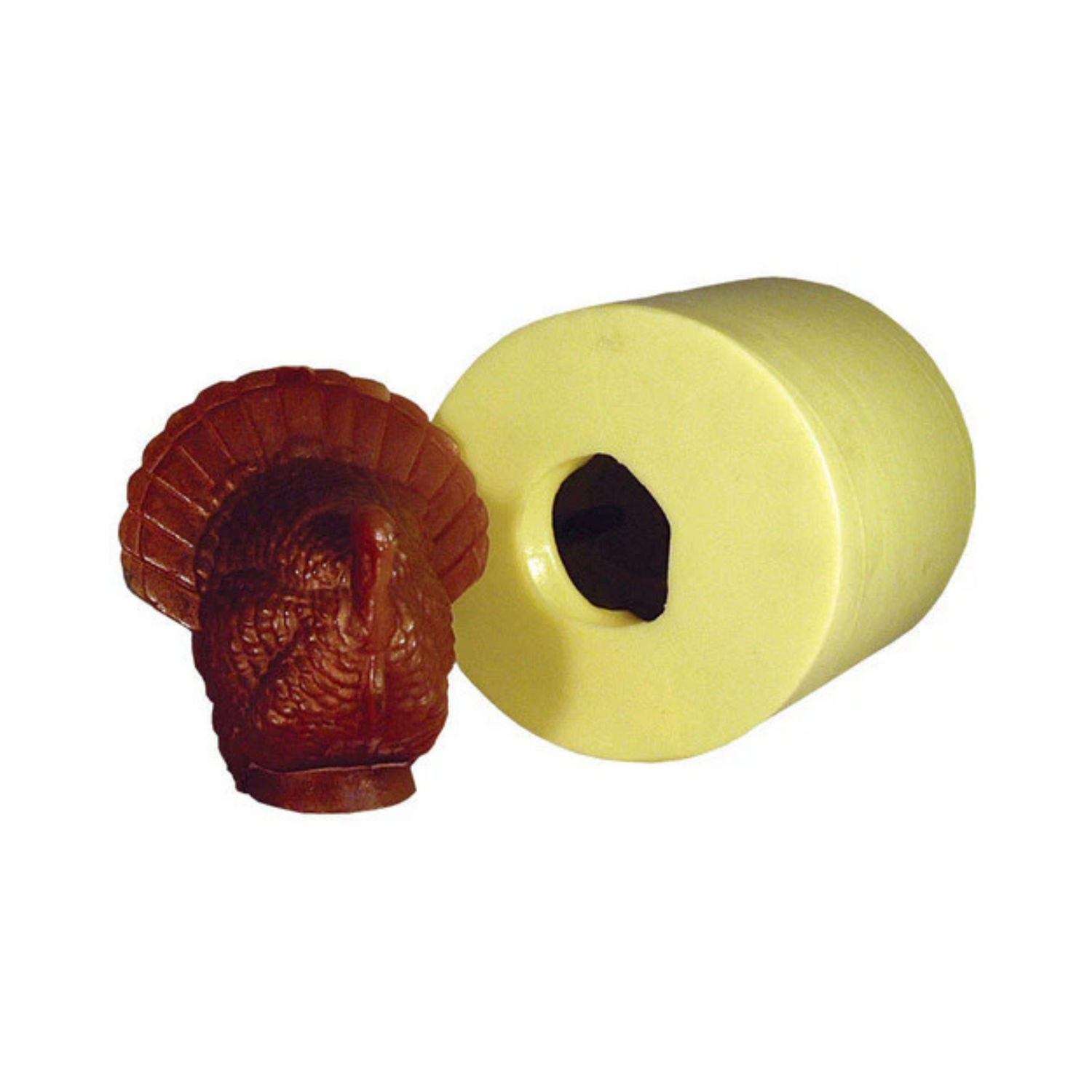 Brown turkey-shaped wax candle next to its yellow candle mold on a white background