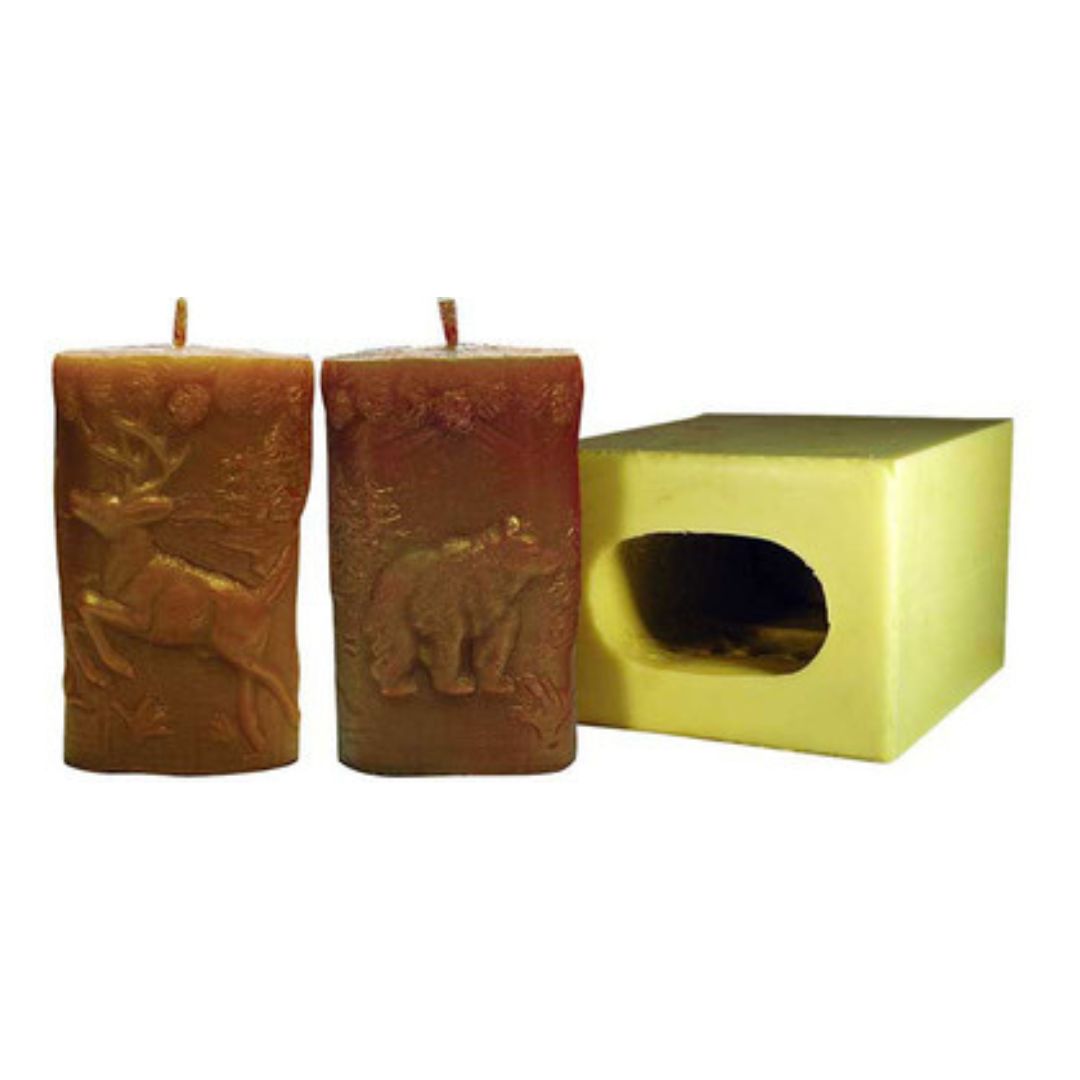 Yellow rectangular candle mold that has a deer and bear design and two brown candles, one with a bear and one with a deer on a white background