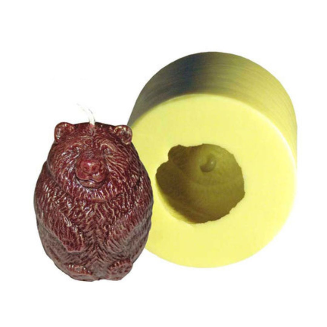A yellow candle mold with a bear design and a brown bear candle produced from the mold on a white background