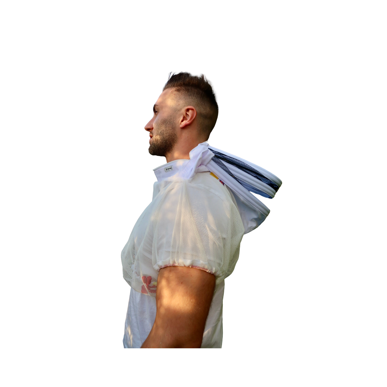 A man shown in side profile wearing a white protective beekeeping jacket with a hood, with a folded white jacket draped over his shoulder, isolated on a white background.