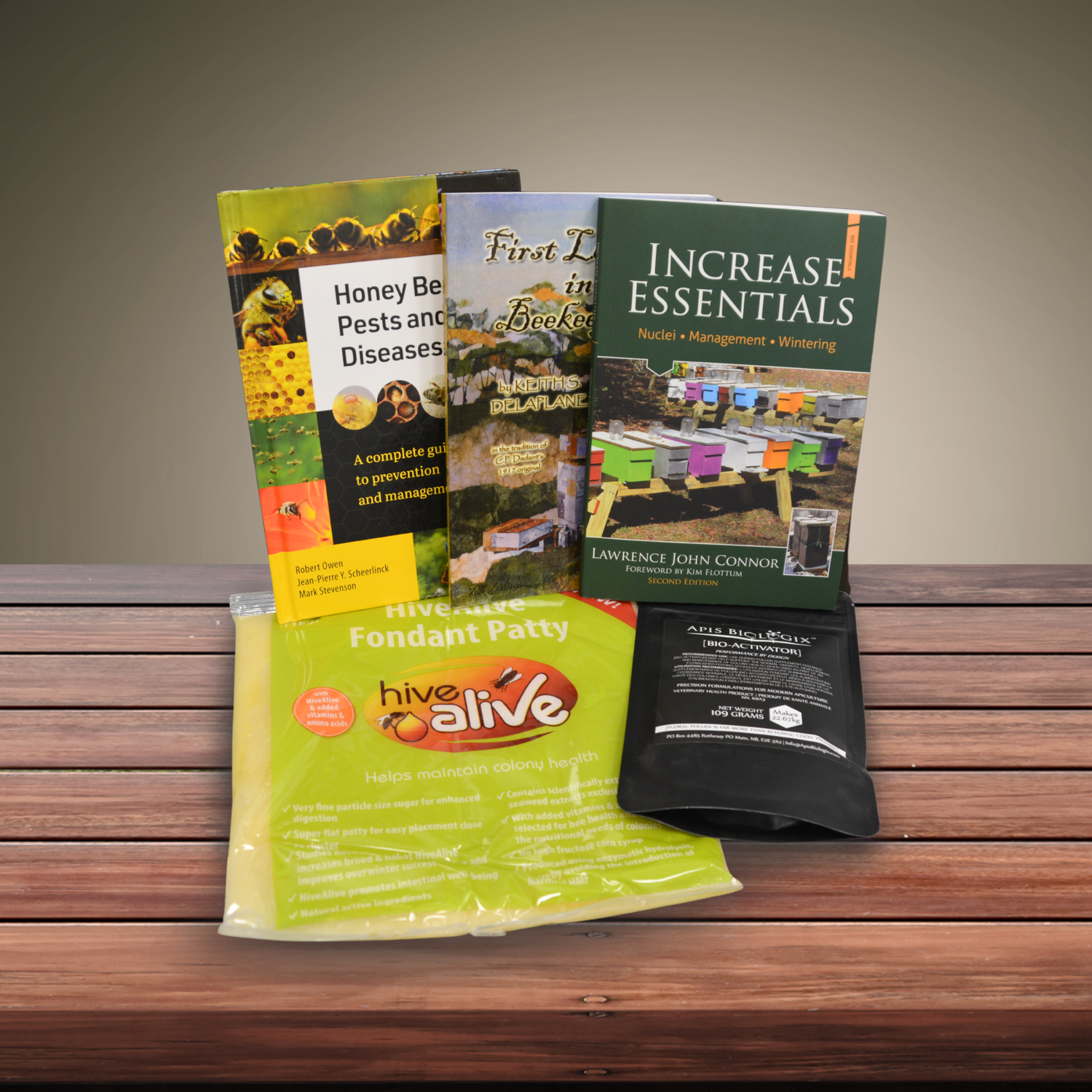 A display showing various beekeeping books as well as supplements used in beekeeping on a wooden desk