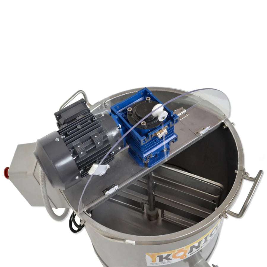 A large, industrial Konigin honey creamer and homogenizer with a capacity of 26 gallons, with the lid opened to expose the interior on a white background