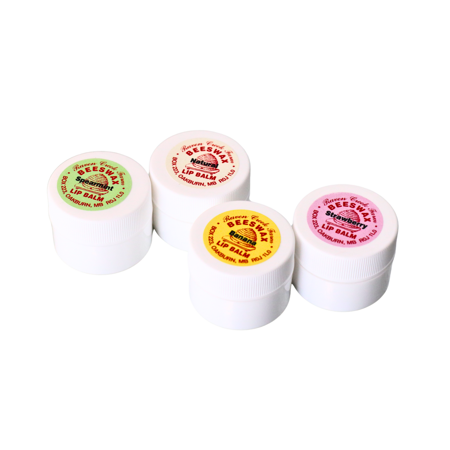 Four containers of Raven Creek Beeswax Lip Balm with different colored lids indicating various flavors on a white background.
