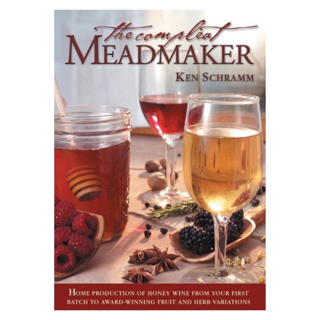 The cover of the book 'The Compleat Meadmaker' by Ken Schramm, featuring glasses of mead, honey, and various fruits on a white background