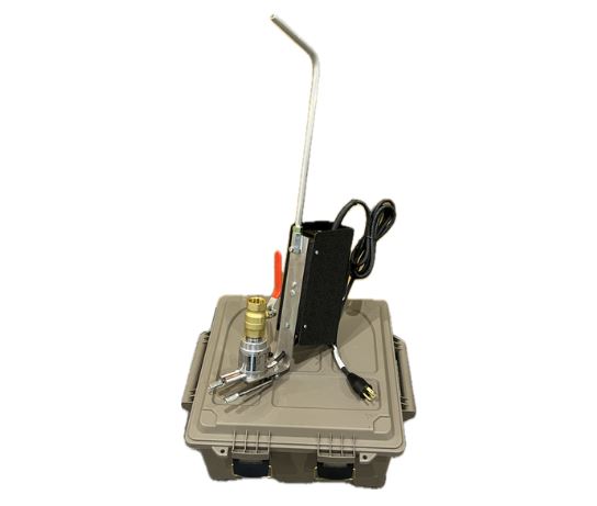 A specialized oxalic acid applicator device with a metallic structure, attached tube, and control switches, set on top of a grey plastic storage case.