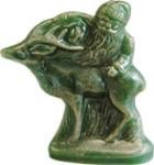 A green candle shaped like Santa Claus and a reindeer on a white background