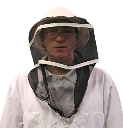 A person wearing a black beekeeping mesh netting veil with an elasticized top and bottom, on a white background.