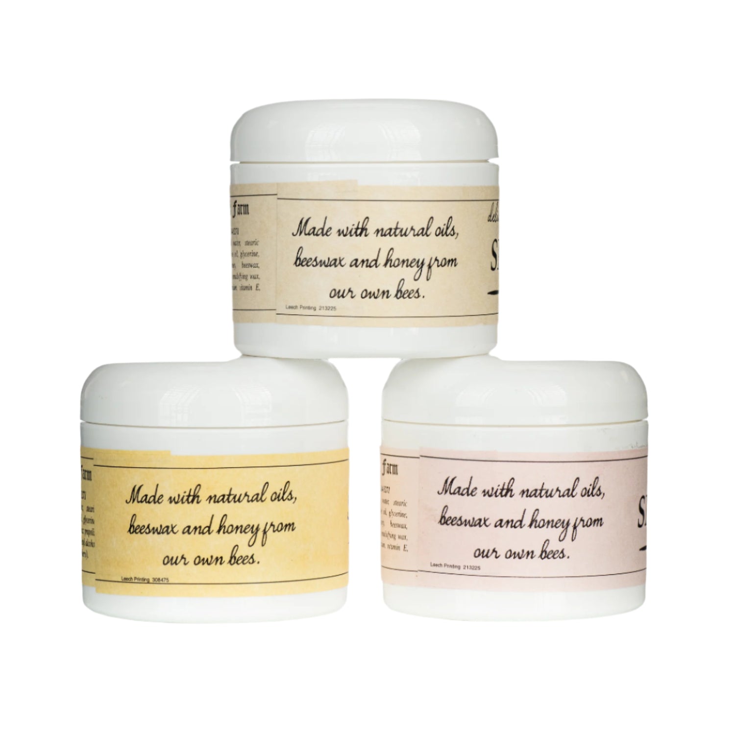 Three jars of skin cream with labels indicating different variations, including natural and unscented, with royal jelly on a white background.