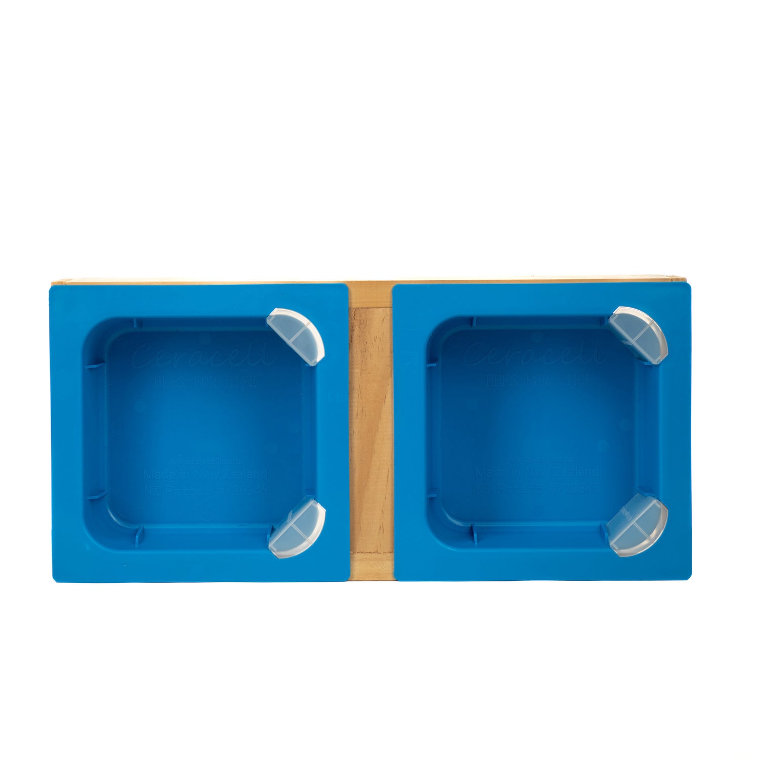 A blue top feeder with a patented corner access system, accompanied by corner caps and a chimney, displayed with its wooden frame assembled.