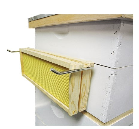 Example of the metal frame holder sitting over the edge of the hive body and supporting frames.