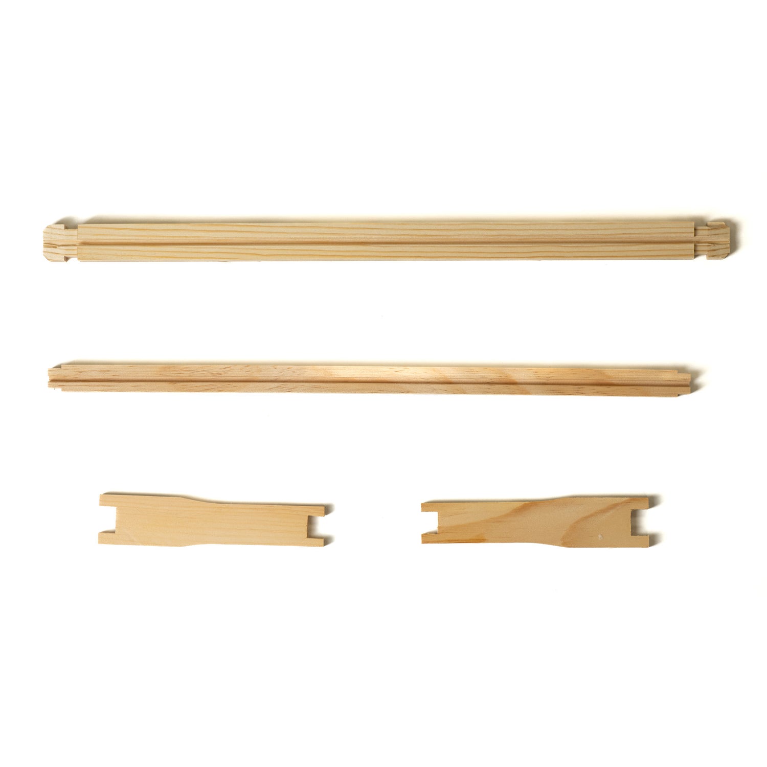 A set of unassembled wooden frame parts for beehives.