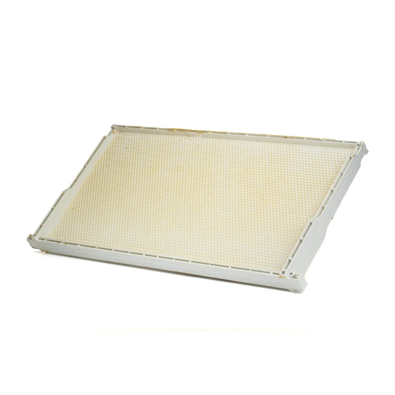 A side view of a white wax-coated plastic frame and foundation for beekeeping, designed to fit into Langstroth supers.