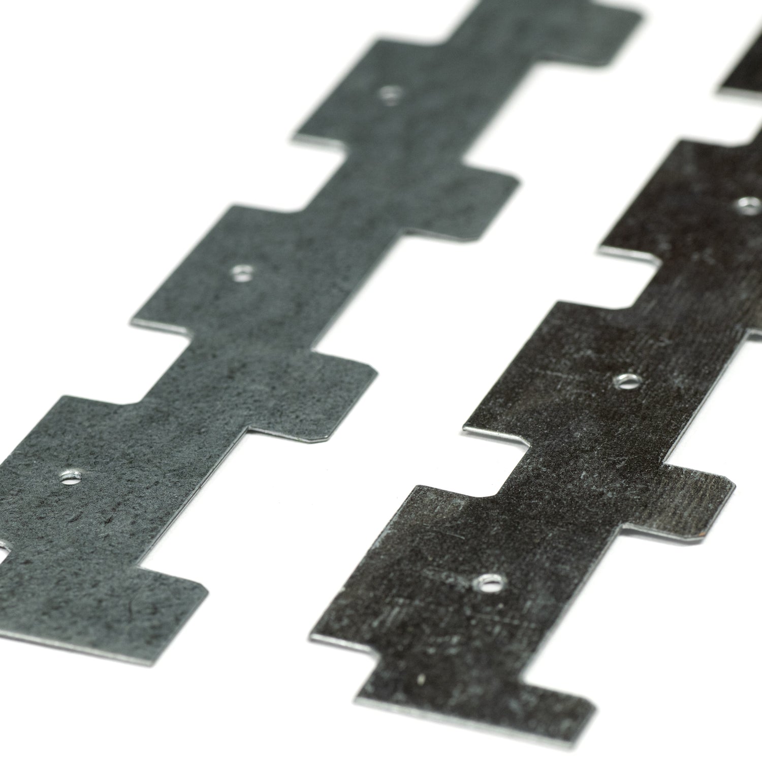 Close up of two metal 9-frame spacer rests used for spacing frames in a beehive.