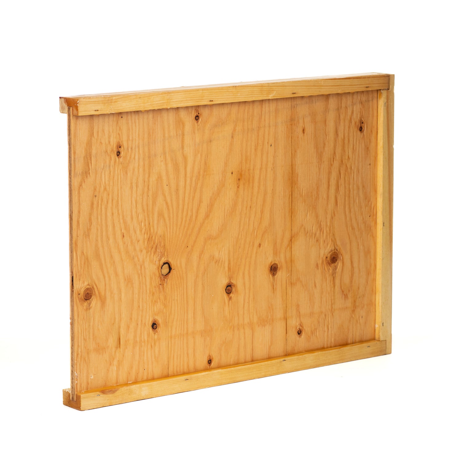 A side view of a wax-dipped wooden hive bottom board.