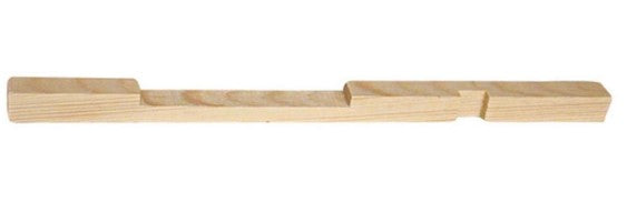 Another view of a wooden entrance reducer for a hive, featuring a notched design to regulate the size of the bottom entrance.