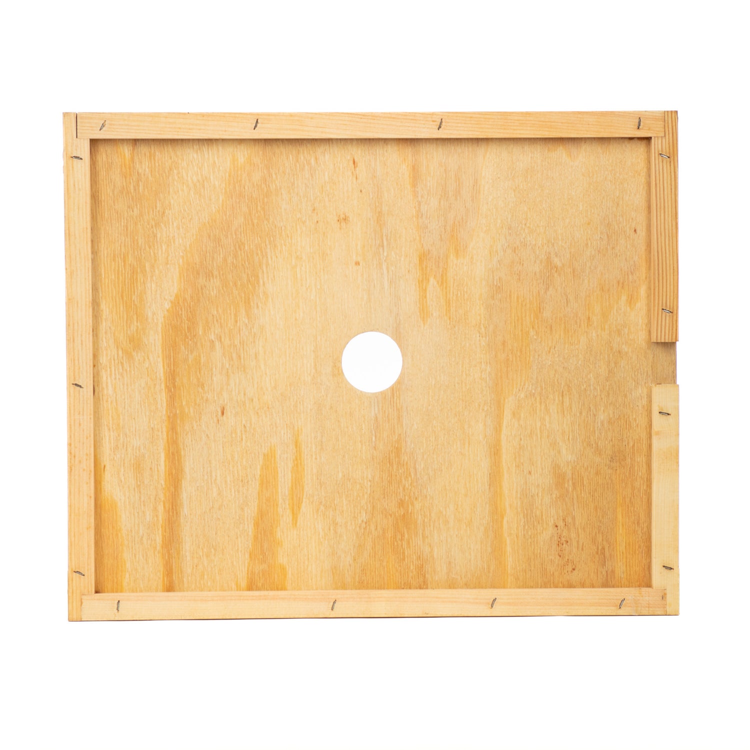 A wooden hive cover board with a central hole and ventilation slit, wax-coated for durability.