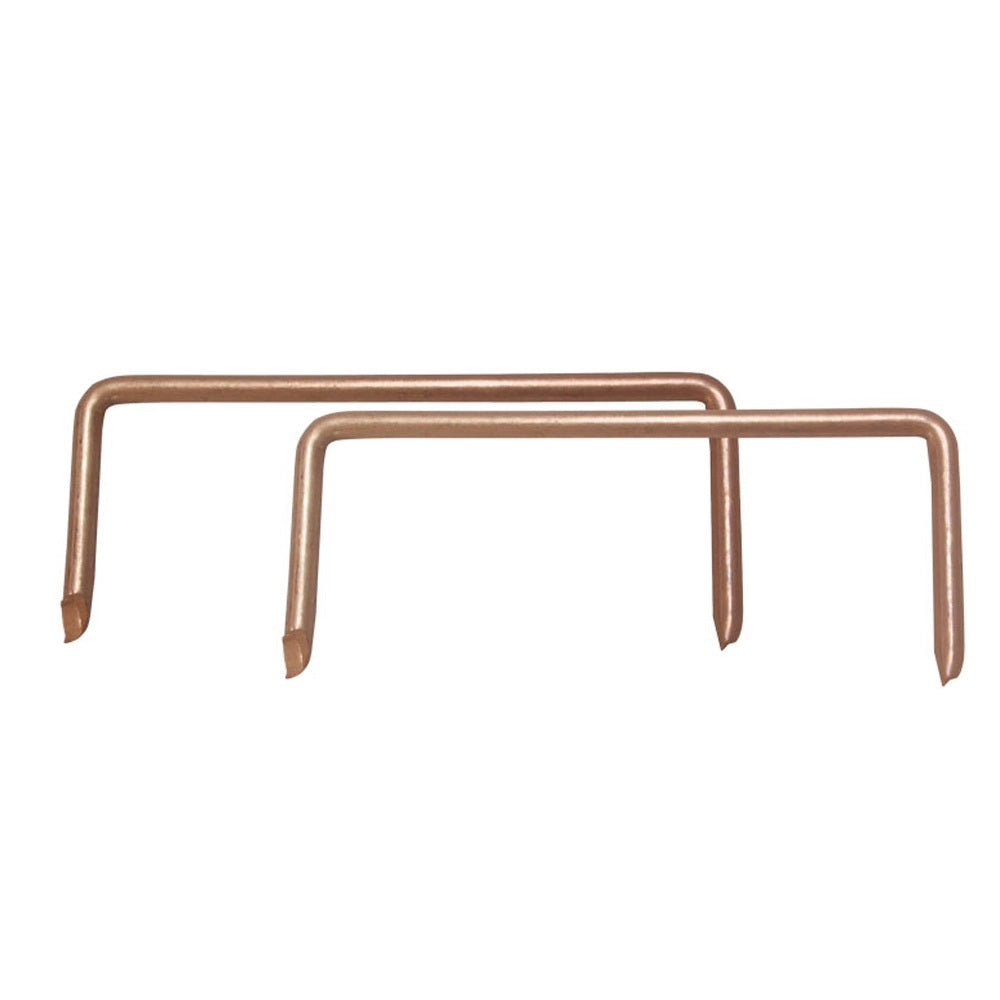 A pair of bronze-colored crating staples, likely made of metal, intended for heavy-duty use, such as fastening bottom boards, on a white background.