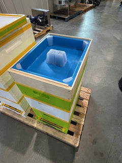Example of blue plastic top feeder in a HiveIQ beehive setup