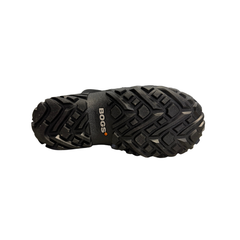 The sole of a black rubber Bogs boot on a white background
