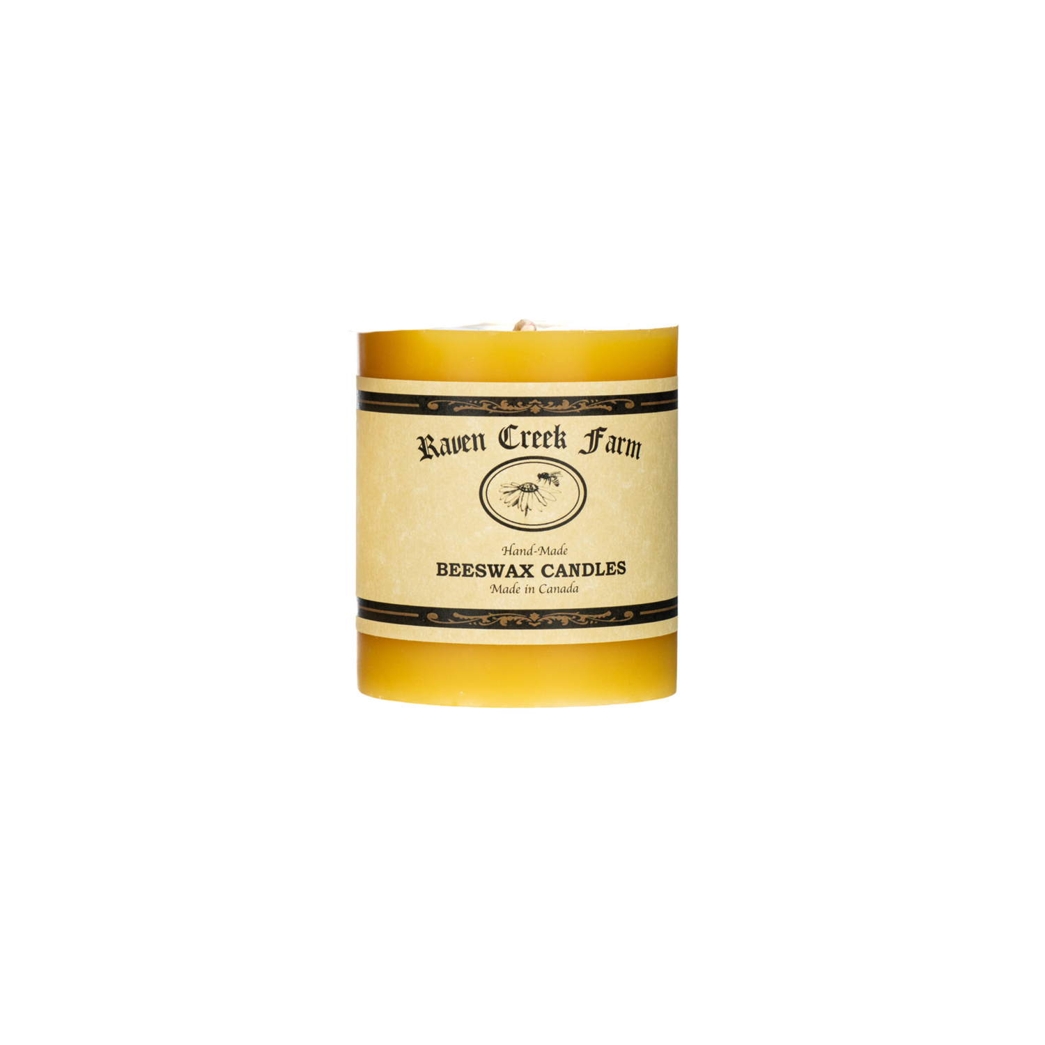 Beeswax pillar candle with 'Raven Creek Farm' label on a white background
