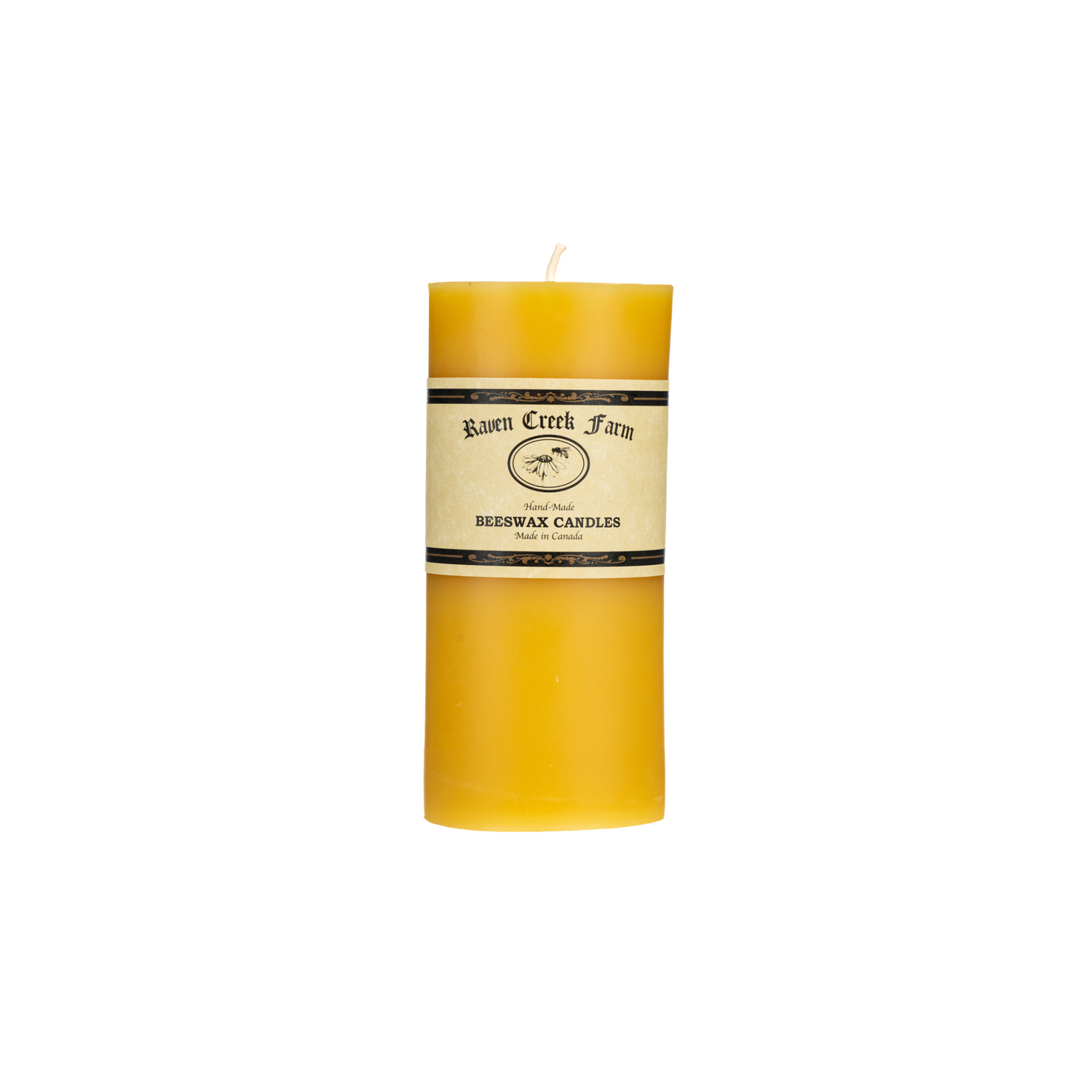 Yellow cylindrical pillar candle with label for 