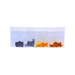 Four packets of dye buds in their own clear plastic packaging against a white background